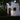White house exterior with a light fixture on a dark evening