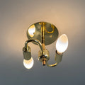 Gold wall-mounted light fixture with 2 bulbs on a gray background