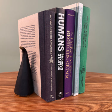 aubock bookend with books on wood table