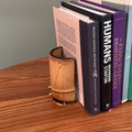 bamboo and brass bookend regency style with books on a wood table