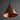 Copper pendant light against a dark background