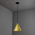 polished brass conical tratten pendant light hanging against a gray wall