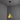 polished brass conical tratten pendant light hanging against a gray wall