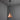 Copper conical pendant light hanging against a gray wall