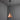 Copper conical pendant light hanging against a gray wall