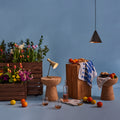 Vintage lamp and tratten pendant in a Decorative setting with flowers, fruits, and wooden furniture against a blue background