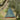 Conical metal lamp hanging from a tree branch with a natural background