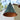 Conical metal lampshades with a rustic finish hanging outdoors.
