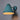 verdigris finish wall sconce with a textured finish on a gray background
