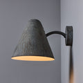 Wall-mounted lamp with textured patina shade on a gray wall indoor or outdoor lighting