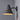 Wall-mounted lamp with textured patina shade on a gray wall indoor or outdoor lighting