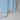 Light blue lamp with a brass label on a light gray background