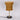Table lamp with mustard yellow shade and gold base on a white background