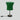Green textile shade table lamp with black and brass stem against a grey background
