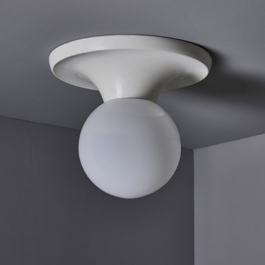 Flos Light Ball Ceiling light fixture with a spherical design on a gray ceiling. 