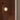 Light fixture on a textured brown wall with a neutral background