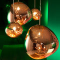 Set of hanging plastic pendant lights with a green background