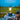 Camping lantern with light bulb on a tablecloth outdoors