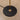 Floor lamp with black base and gold pole on a beige concrete floor.