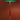Floor lamp with a green shade and gold base against a red wall