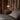 Bedroom with wooden wall paneling and a bedside table with a PH 2/1 portable chrome table lamp from louis poulsen