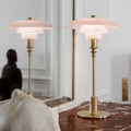 Pair of poulsen pale rose 2/1 table lamps with pink glass shades on a marble surface.