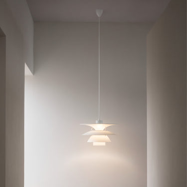Poulsem PH 5-4½ Pendant light fixture hanging in a room with neutral walls.