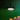 Modern black pendant light over a dining table with chairs against a green wall