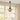 Pendant light hanging above a table with decorative items in a room with large windows.
