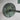 Rustic metal wall sconce with a greenish patina on a white background