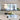 PH 5-4½ white Modern kitchen with a dining table featuring a vase of flowers and a candle.