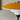 table lamp with yellow and white shade on a neutral wall.
