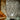 Decorative glass lamp on a wooden surface with a textured wall background