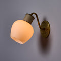 Wall-mounted lamp with a warm light bulb on a gray background