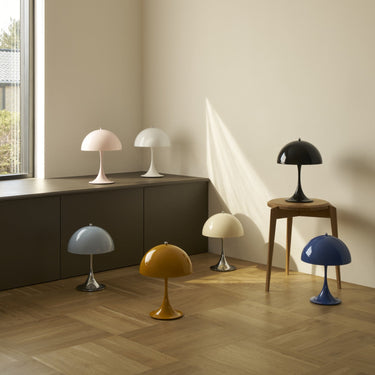 Various table lamps on a wooden floor with a neutral wall background
