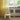 White chair in a room with yellow curtains and a radiator.