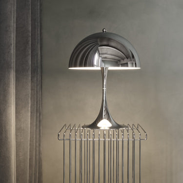 Modern silver chrome 1970s style table lamp with a textured shade on a neutral background