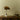 Brown Panton Pantella lamp on a warm wood surface with a ceramic bowl