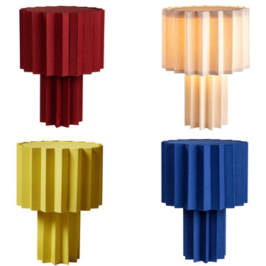 Four colorful geometric textile plissé lamps on a white background