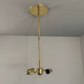 Gold wall-mounted lamp fixture on a plain white wall