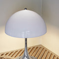 Table lamp with a white shade on a marble surface