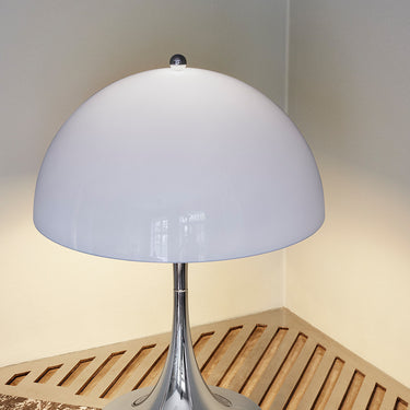 Table lamp with a white shade on a marble surface