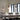 Three modern pendant lights with white shades and warm wood-toned tops hang over a dining table with white chairs in a bright room with tall windows and curtains.