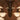Chandelier with multiple light bulbs against a brown background