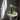 Green lamp on a small round table with a dark wall background