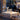 Dining table set with wine glasses and a lamp, viewed through a glass door.