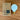 Tala light bulb and packaging on a wooden surface