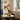 Dining area with gold pendant lights, round table, and black chairs.