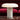 Marble table lamp on a marble surface with a red cushioned background