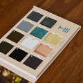 Color swatch book on a wooden surface